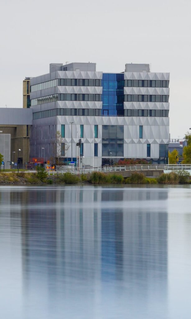 wide-range-view-of-high-rise-building-casting-reflection-on-water-surface